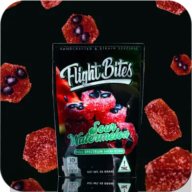 Watermelon gummy with candy watermelon seeds inside tossed in sour sugar.